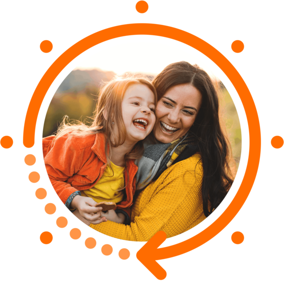 Mother and daughter laughing and hugging outdoors, framed by an orange circular graphic with dots and an arrow, symbolizing joy and energy.